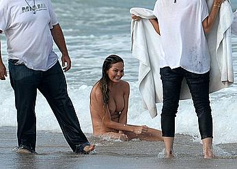 Chrissy Teigen topless during photoshoot at Miami Beach