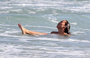 Chrissy Teigen topless during photoshoot at Miami Beach