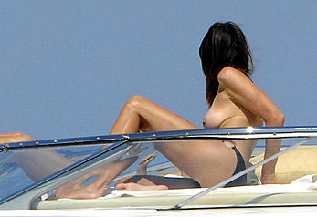 Cindy Crawford sunbathing topless on a yacht