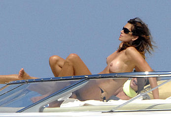 Cindy Crawford sunbathing topless on a yacht