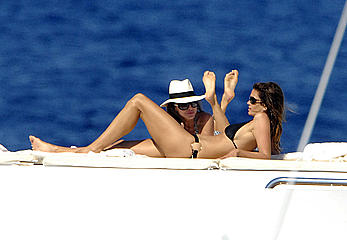 Cindy Crawford sunbathing topless on a yacht