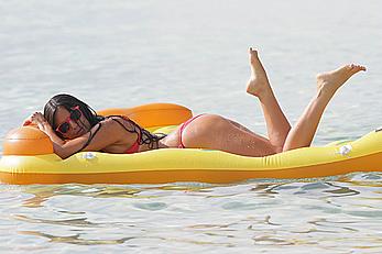 Claudia Romani in red bikini on a beach in Miami