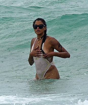 Claudia Jordan tit slip and see through in wet swimsuit