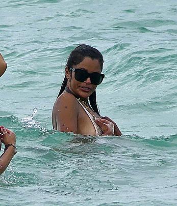 Claudia Jordan tit slip and see through in wet swimsuit