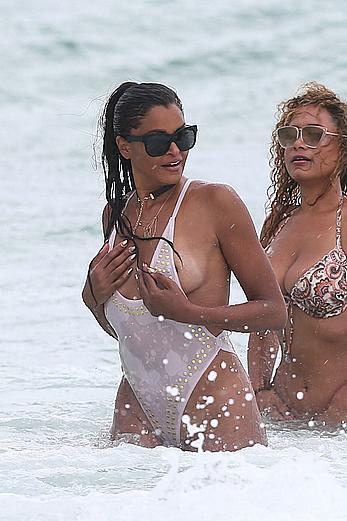 Claudia Jordan tit slip and see through in wet swimsuit