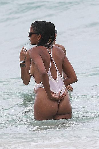 Claudia Jordan tit slip and see through in wet swimsuit