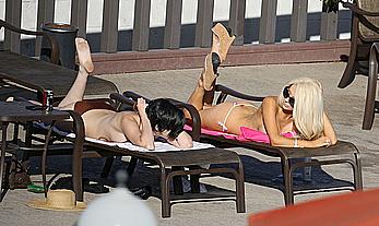 Busty Courtney Stodden getting close with a girlfriend whilst laying poolside