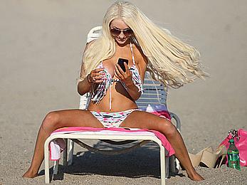 Busty Courtney Stoddensunbathing almost topless at Ventura Beach