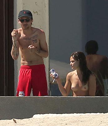 Danielle Campbell toless at a pool in Cabo San Lucas