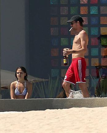 Danielle Campbell toless at a pool in Cabo San Lucas