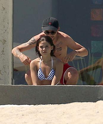 Danielle Campbell toless at a pool in Cabo San Lucas