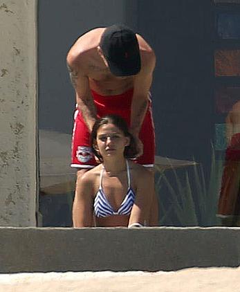 Danielle Campbell toless at a pool in Cabo San Lucas