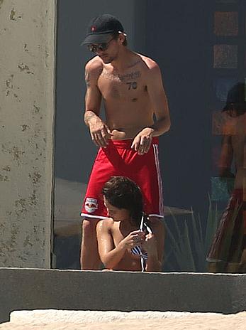 Danielle Campbell toless at a pool in Cabo San Lucas