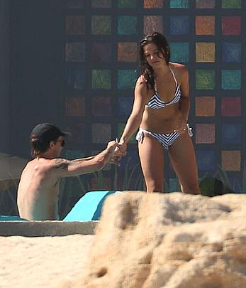 Danielle Campbell toless at a pool in Cabo San Lucas