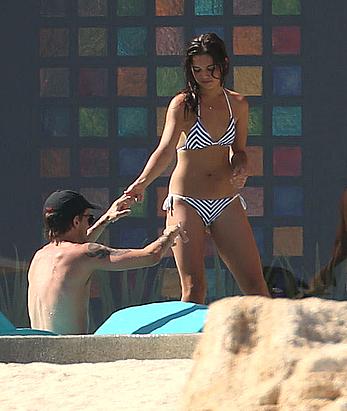 Danielle Campbell toless at a pool in Cabo San Lucas