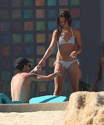 Danielle Campbell toless at a pool in Cabo San Lucas