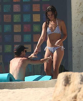 Danielle Campbell toless at a pool in Cabo San Lucas