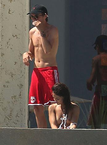 Danielle Campbell toless at a pool in Cabo San Lucas