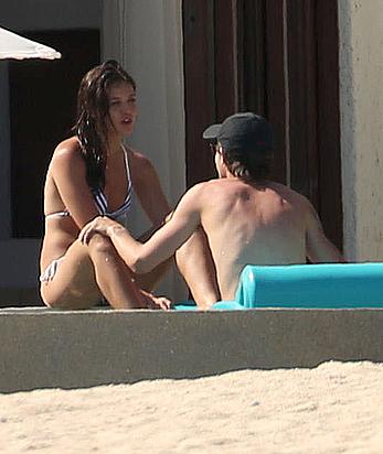 Danielle Campbell toless at a pool in Cabo San Lucas