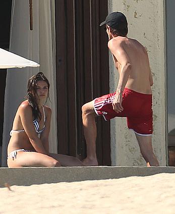 Danielle Campbell toless at a pool in Cabo San Lucas