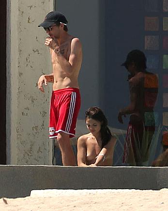 Danielle Campbell toless at a pool in Cabo San Lucas