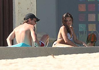 Danielle Campbell toless at a pool in Cabo San Lucas