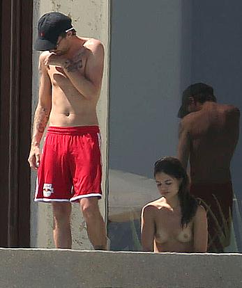 Danielle Campbell toless at a pool in Cabo San Lucas