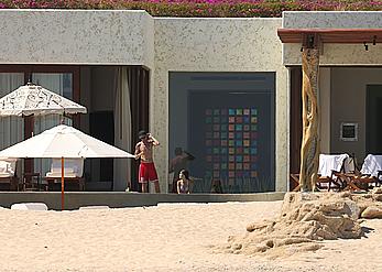 Danielle Campbell toless at a pool in Cabo San Lucas