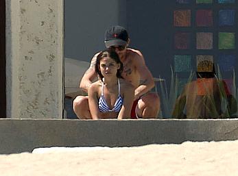 Danielle Campbell toless at a pool in Cabo San Lucas