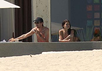 Danielle Campbell toless at a pool in Cabo San Lucas