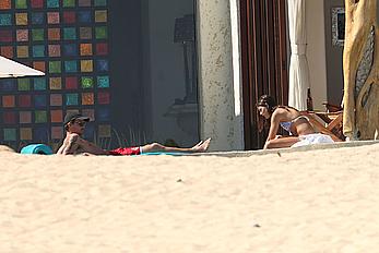 Danielle Campbell toless at a pool in Cabo San Lucas