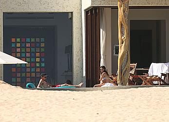 Danielle Campbell toless at a pool in Cabo San Lucas