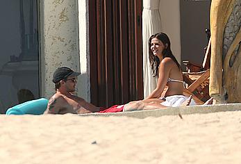 Danielle Campbell toless at a pool in Cabo San Lucas