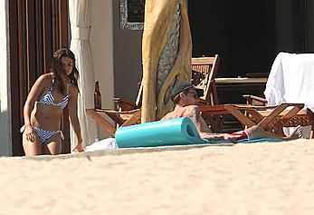 Danielle Campbell toless at a pool in Cabo San Lucas