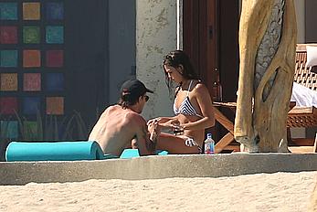 Danielle Campbell toless at a pool in Cabo San Lucas