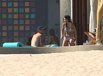 Danielle Campbell toless at a pool in Cabo San Lucas