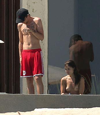 Danielle Campbell toless at a pool in Cabo San Lucas