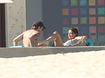 Danielle Campbell toless at a pool in Cabo San Lucas