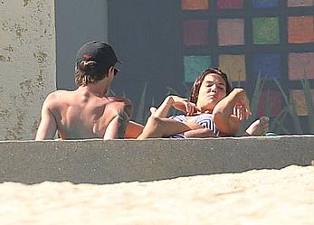 Danielle Campbell toless at a pool in Cabo San Lucas