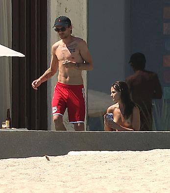 Danielle Campbell toless at a pool in Cabo San Lucas