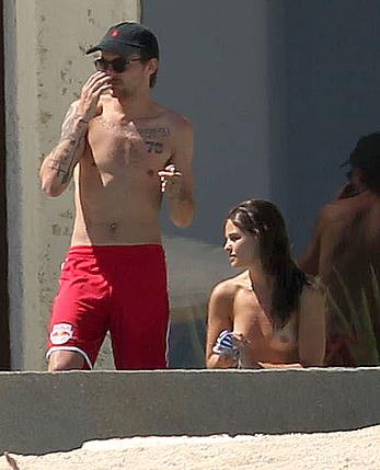 Danielle Campbell toless at a pool in Cabo San Lucas