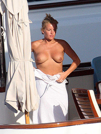 Blonde Davinia Taylor sunbathing topless in Italy