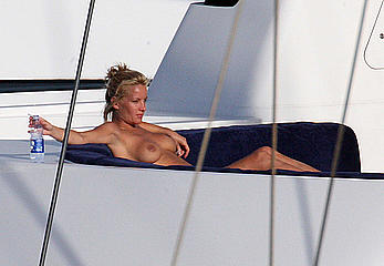 Blonde Davinia Taylor sunbathing topless in Italy