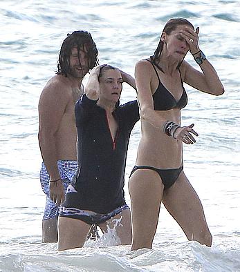 Drew Barrymore pokies in wet top at a beach in Miami