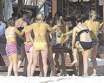 Drew Barrymore pokies in wet top at a beach in Miami