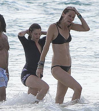 Drew Barrymore pokies in wet top at a beach in Miami