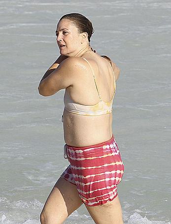 Drew Barrymore pokies in wet top at a beach in Miami