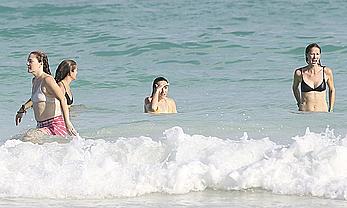 Drew Barrymore pokies in wet top at a beach in Miami