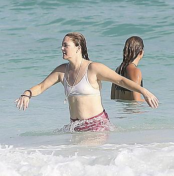 Drew Barrymore pokies in wet top at a beach in Miami