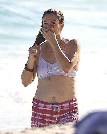 Drew Barrymore pokies in wet top at a beach in Miami